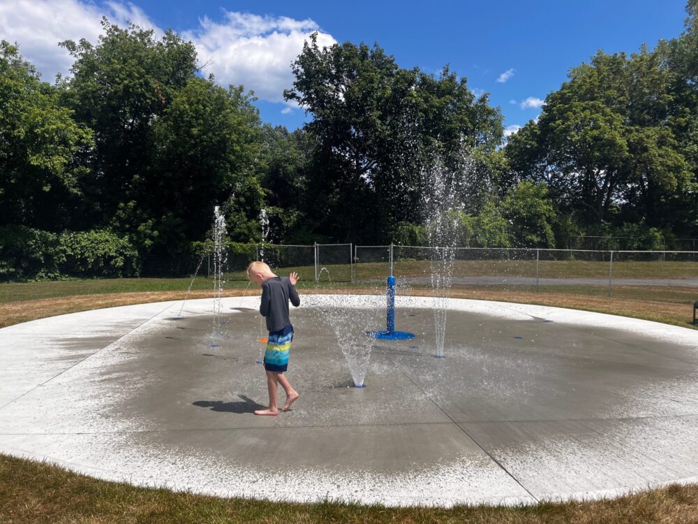boy playing in splash pad